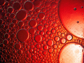 Abstract Background Red oil Macro Colorful artistic of oil drop floating on the water. macro red bubble oil of wallpeper, blood concept