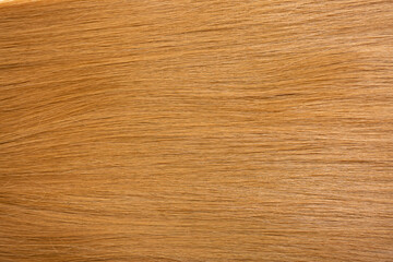 Red hair close-up as a background. Women's long orange hair. Beautifully styled wavy shiny curls....