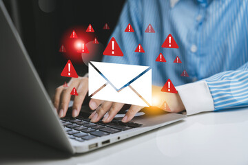 Person typing on a laptop, with email alerts and notifications symbolizing urgency and communication.