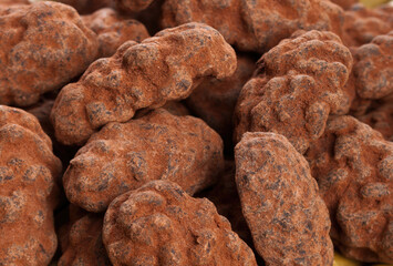 Chocolate covered pecans forming a textured background