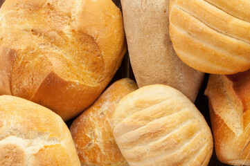 Variety of rustic bread loaves baking in a basket