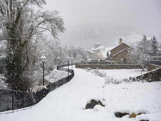 Idilica snowy street in a town of the Aragonese Pyrenees. Spain.