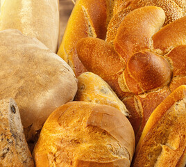 Variety of freshly baked bread forming food background