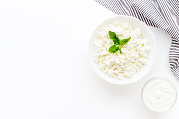 Farm cottage cheese in white bowl, top view. Healthy protein breakfast
