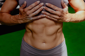 Athletic female figure close-up, flat stomach with cubes