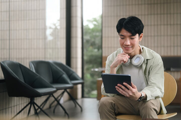 Digital Reading in a Quiet Cafe with Smart Young adult man