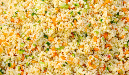 Vegetarian couscous salad with carrots zucchini and herbs