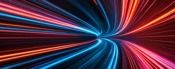 Fototapeta premium Colorful light trails in motion on a dark background.