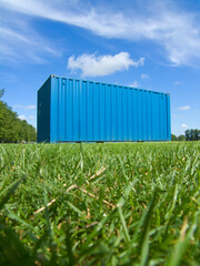 A container used for goods transporation and shipping. viewed in an isolated outdoor location