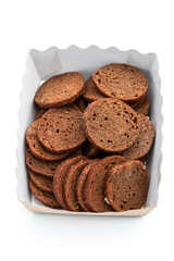 Rye bread crackers in paper bowl isolated on white background