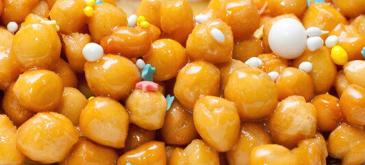 Delicious struffoli, italian honey balls, forming a background image