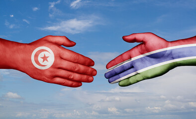 Gambia and Tunisia country handshaking with flags, consensus concept international co-operation illustration