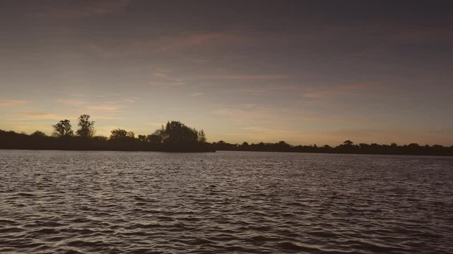 Filming of the Tejo  River in Portugal with sunset and trees.