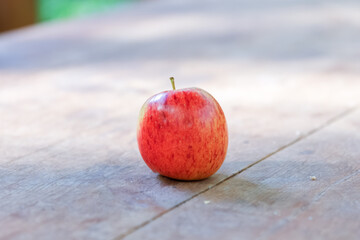 Fresh red apples on a wooden background. Fruits with copy space, concept on the theme of healthy nutrition and diet.