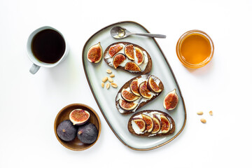 Healthy vegetarian meal snack on the table - fig sandwiches with cheese and honey, top view