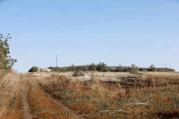 View from the field on the way to the old abandoned village, rustic houses built from wood.