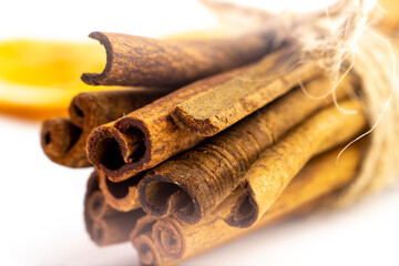 Cut orange and different spices  on white background. Traditional festive winter beverage.Cinnamon, dried orange, anise and cloves