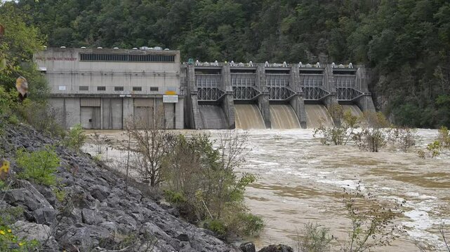 Fort Patrick Henry Dam, spilling, muddy flood waters from four spillways after hurricane Helene. Located in Sullivan County in Kingsport, Tennessee on the South Fork Holston River.