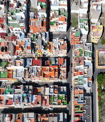 Colored roofs and houses in the village on Tenerife island, top view from a drone.