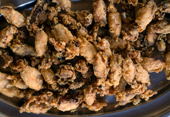 A plate with fried small delicious cuttlefish, grilled seafood closeup.
