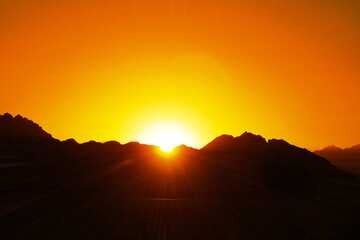  the sun sets over the mountains in the desert     