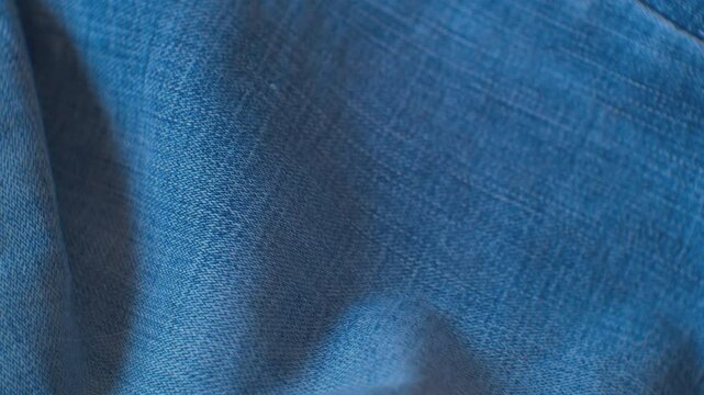 Beautiful vintage blue denim fabric. Moving background. Close-up