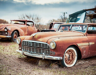 Fototapeta premium Classic American vehicles rusting away in a Retro Dystopia background