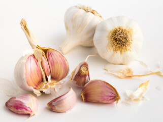 Garlic heads and cloves on white background