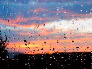 raindrops on the window and bright sunset