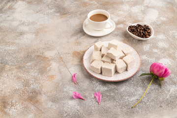 Coffee marshmallow with cup of coffee on brown concrete. side view, copy space.