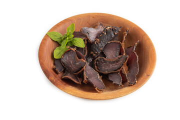 Armenian Basturma dried meat on wooden bowl isolated on white. Side view