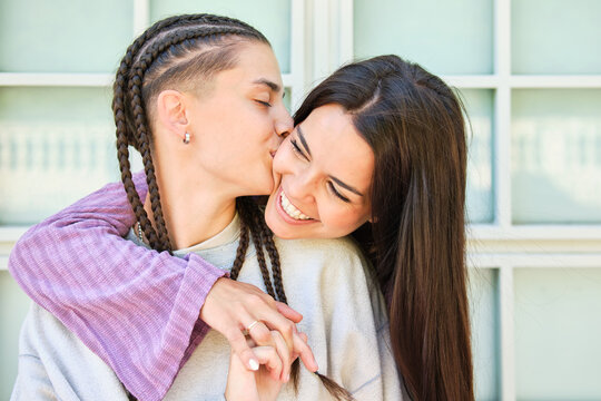 Heartwarming moment between lesbian couple sharing a kiss