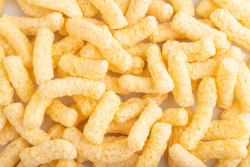 Corn flakes sticks with caramel isolated on white, top view, close up.