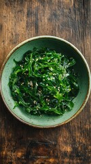 Seaweed salad in ceramic bowl on wooden