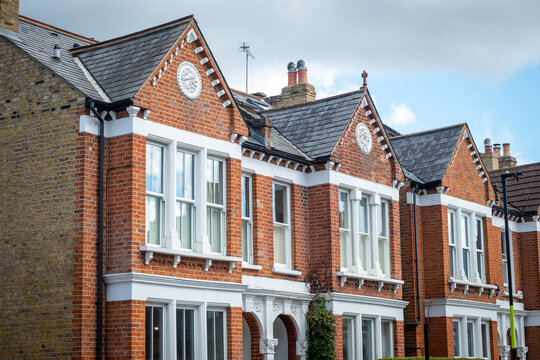 Street of typical British brick terraced houses in suburban London- UK
