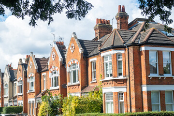 Street of typical British brick terraced houses in suburban London- UK