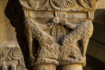 wolves in sheep's clothing devouring a ram, Romanesque capital in the cloister, San Pedro el Viejo Monastery, Huesca, Aragon community, Spain