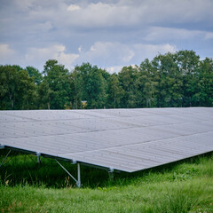 solar energy farm with large photovoltaic panels in rural area