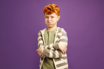 Red Haired Naughty Boy Crossed Arms Pouting Resentfully Standing on Violet Isolated