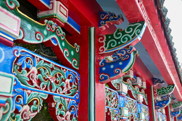 Fototapeta premium Close-up of the ornate decor on the Mengjia Longshan Temple in Taipei, Taiwan. Chinese folk religion landmark. Buddhist Temple. Religious and traditional Chinese art. 