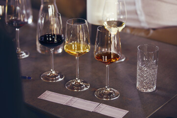 Layout of wine glasses on the table, preparing for the tasting of alcoholic beverages. Preparation...