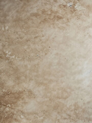 Obraz premium A close-up of a textured beige surface. The surface has a pattern of lines and dots, and appears to be made of a material that looks like metal or stone.