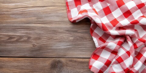 Red and white checkered tablecloth on a wooden background