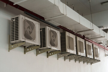 Air compressor or air condenser unit located on support outside building to heat released...