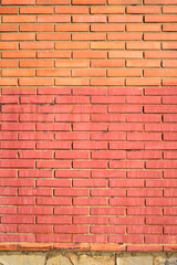Pared de ladrillo pintado  de rojo en exterior soleado