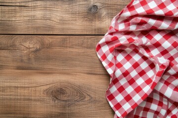 Red and white checkered tablecloth on a wooden background