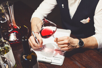 Degustation process with glassware, decanter on table.