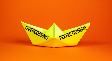 Overcoming perfectionism symbol. Concept words Overcoming perfectionism on beautiful yellow paper...