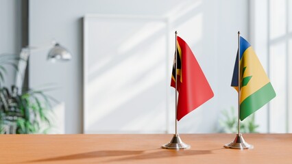 FLAGS OF EAST TIMOR AND SAINT VINCENT ON TABLE
