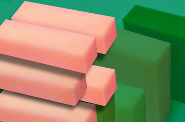 Obraz premium block shaped pink sponge foam material on blurred green background